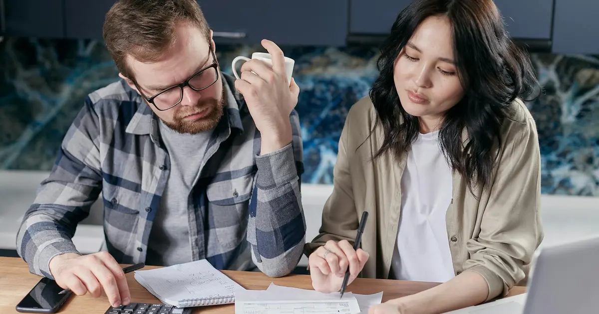 Couple calculant son budget pour acheter un appartement neuf